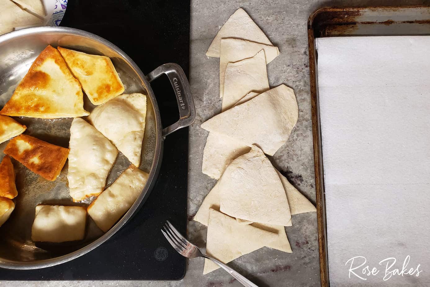 indian fry bread in a skillet, some on the ocunter, and a cookie sheet with apper towel