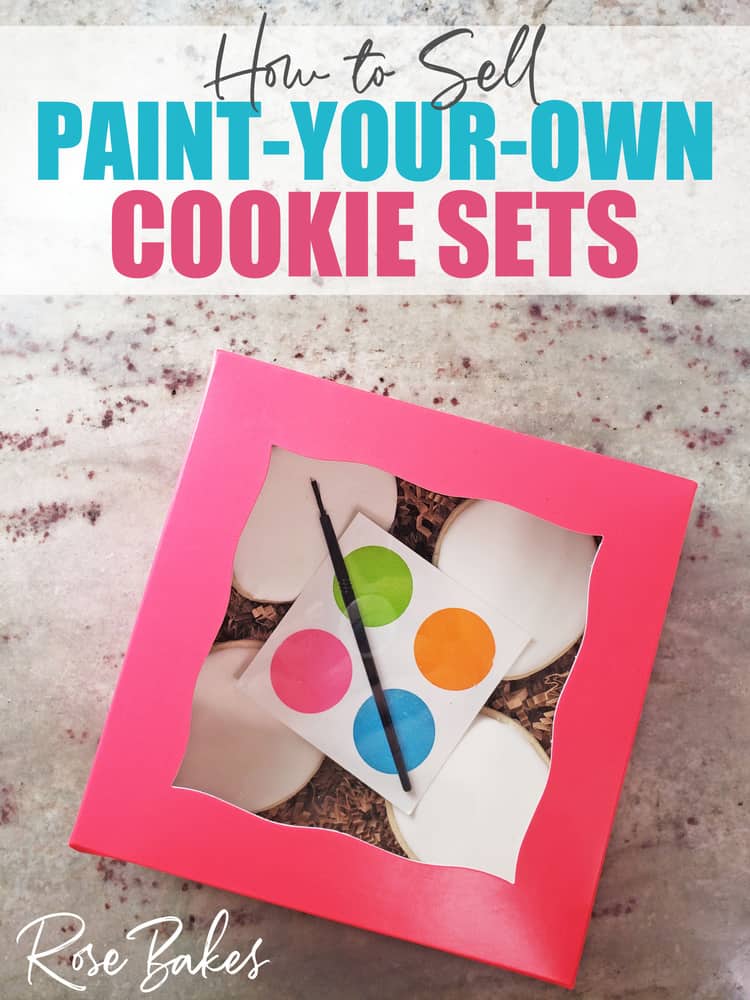 How to Sell Paint Your Own (PYO) Cookie Sets - No Cookie Decorating Required! A pink box of plain white cookies with a palette and paintbrush for clients.