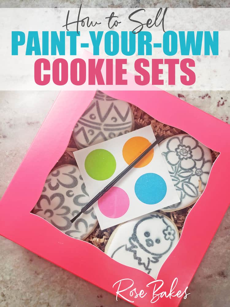 How to Sell Paint Your Own (PYO) Cookie Sets - No Cookie Decorating Required! A pink box of stenciled cookies with a palette and paintbrush.