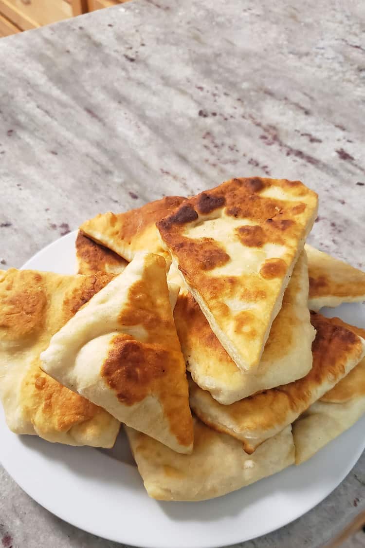 indian fry bread stacked on a plate