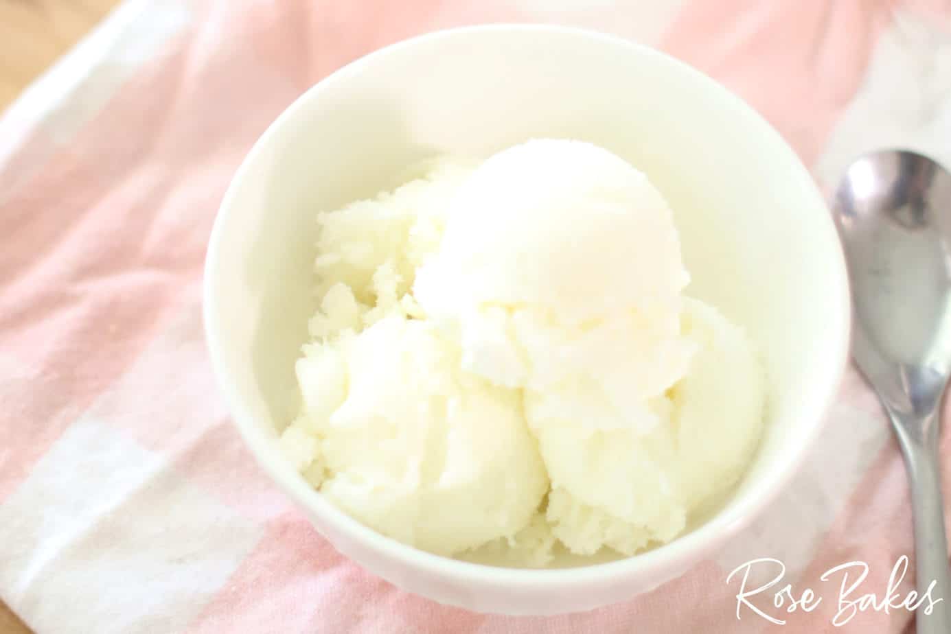 Easy Homemade Vanilla Ice Cream in a white bowl on pink cloth