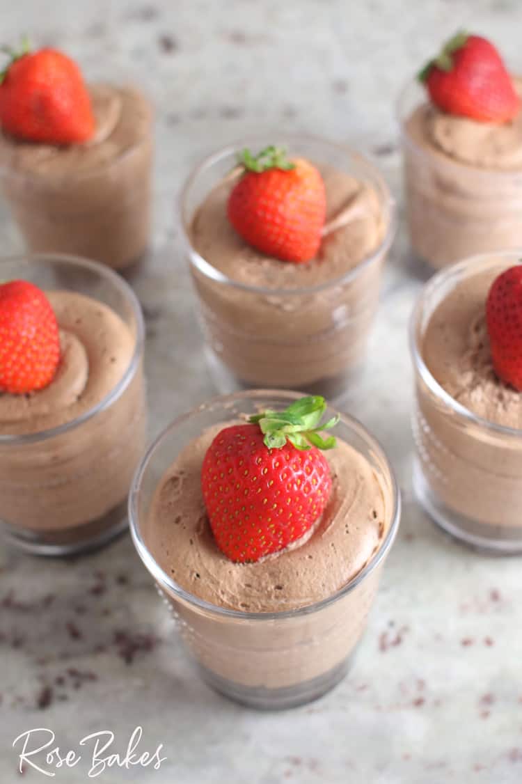 Creamy No-Bake Chocolate Cheesecake Cup in small clearglass with cookie crust and topped with strawberry