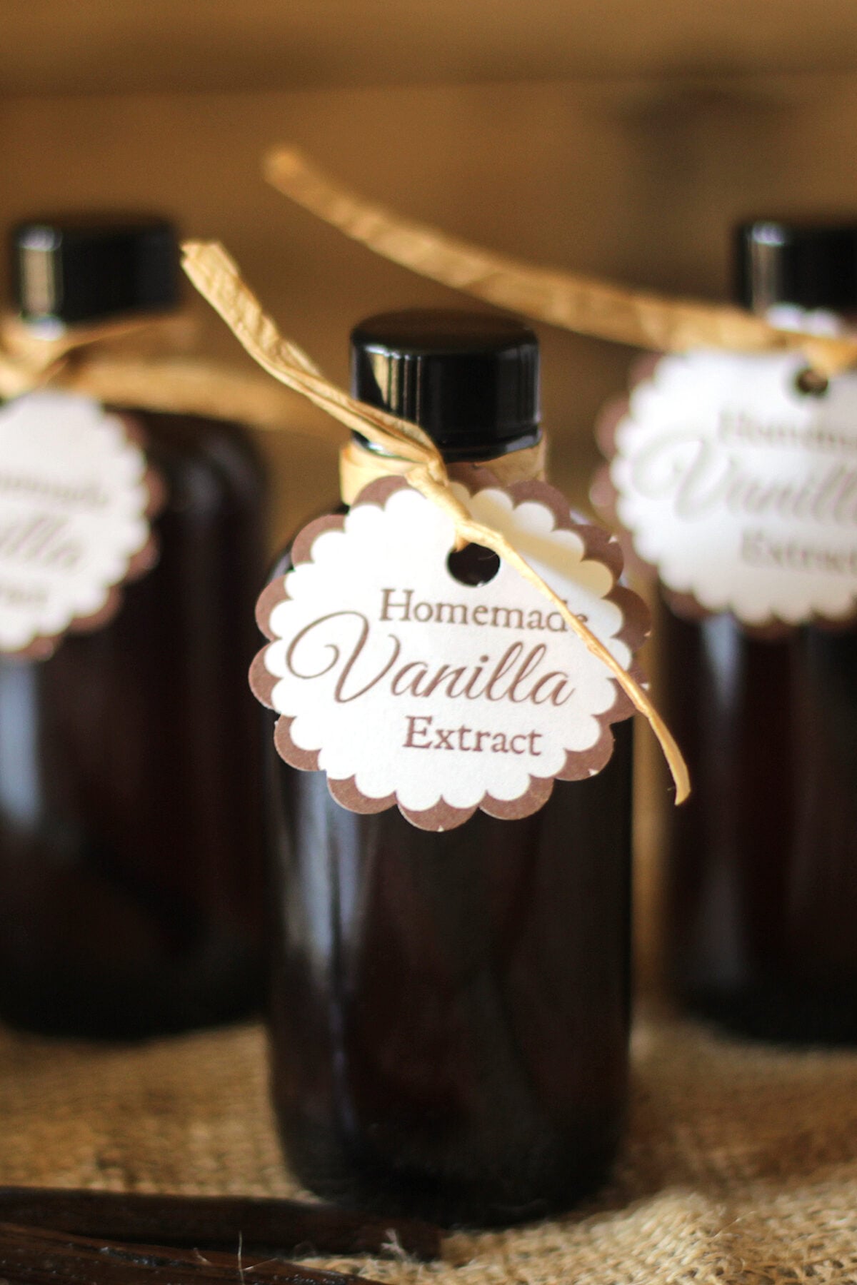 small bottles of homemade vanilla extract with tag and label for gifting