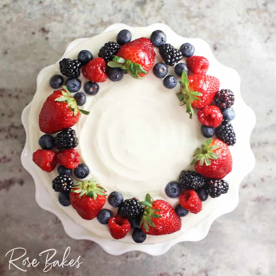 Top view of a chantilly cake with a fresh berry wreath
