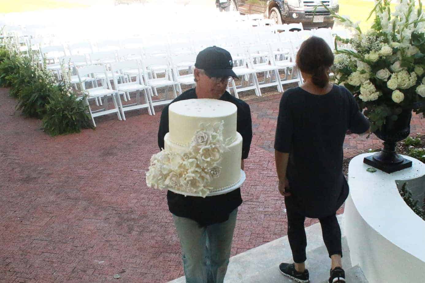 Man carrying 2 layers of wedding cake