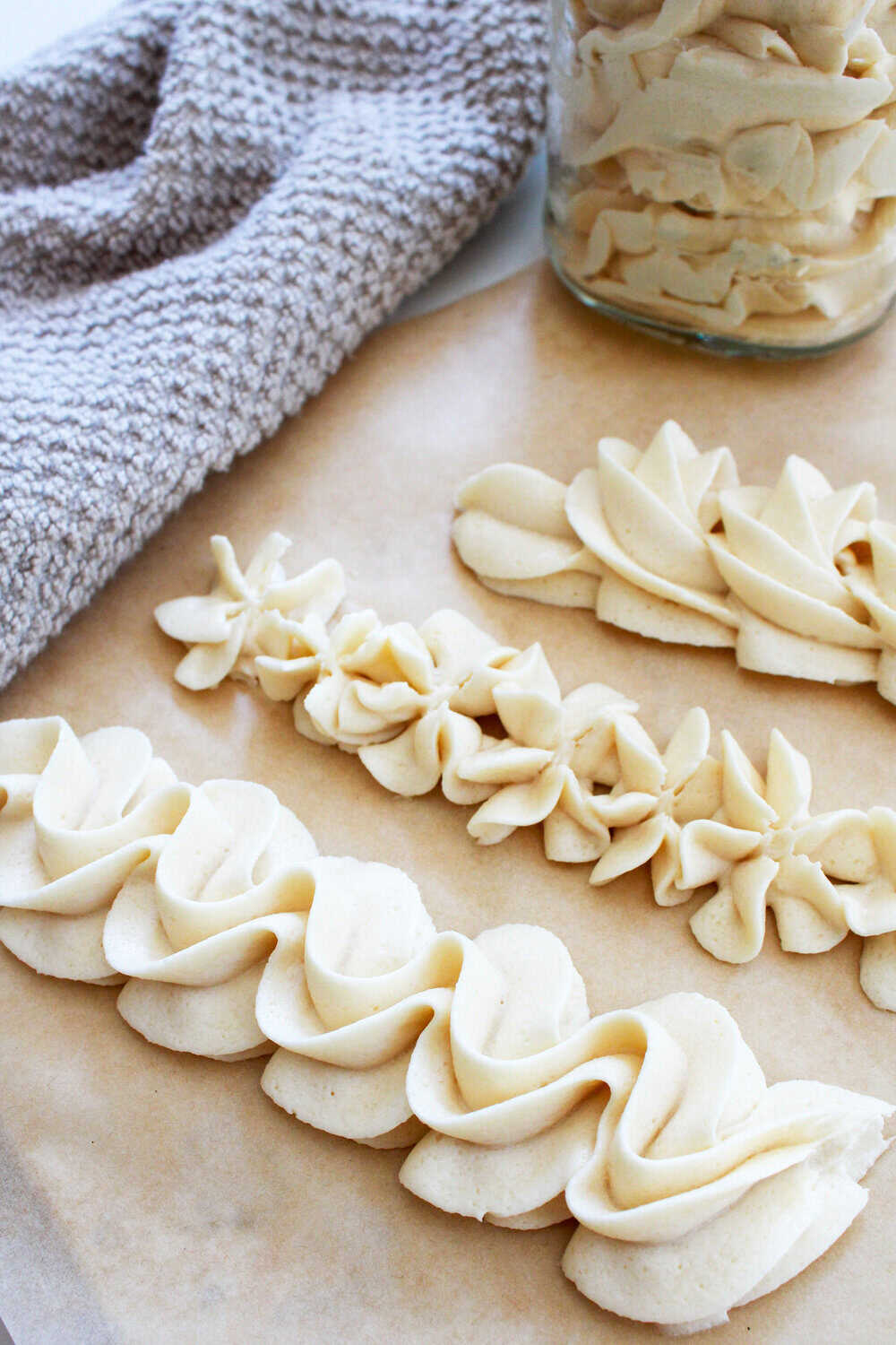 brown sugar buttercream piped in different patterns on brown paper