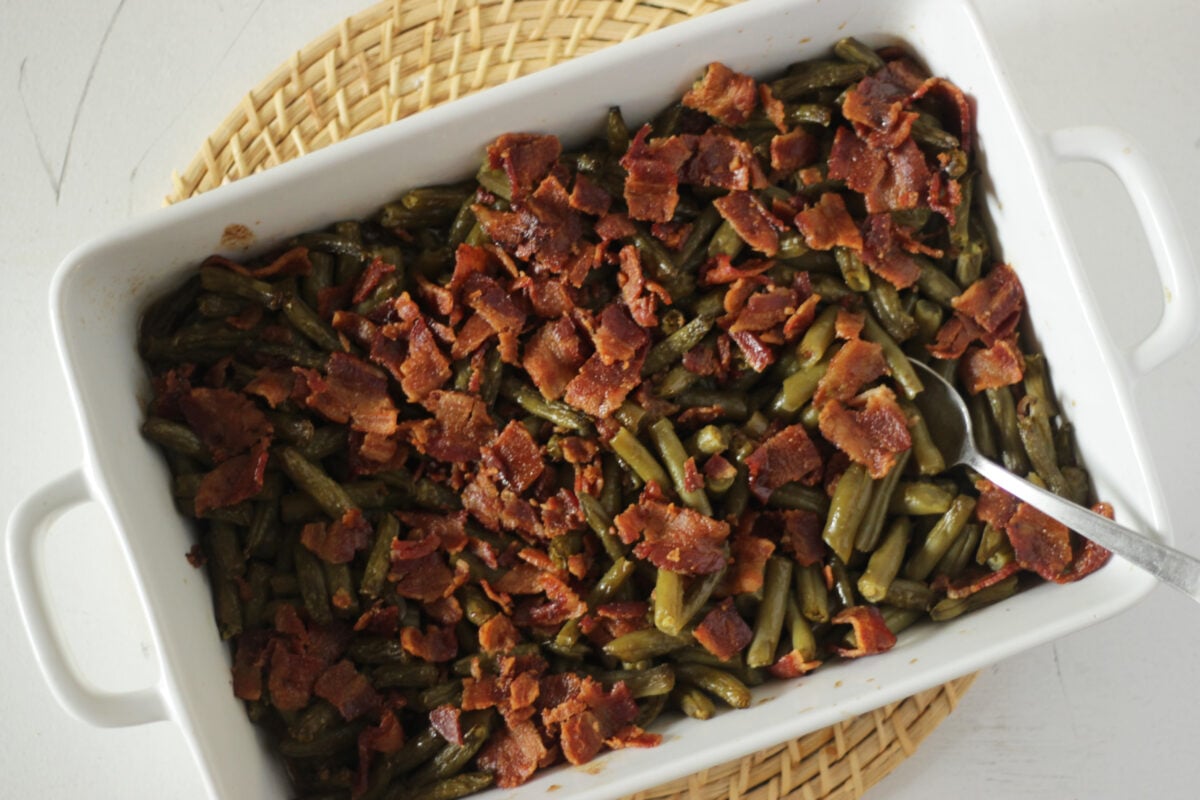 green beans with bacon and brown sugar in a casserole dish