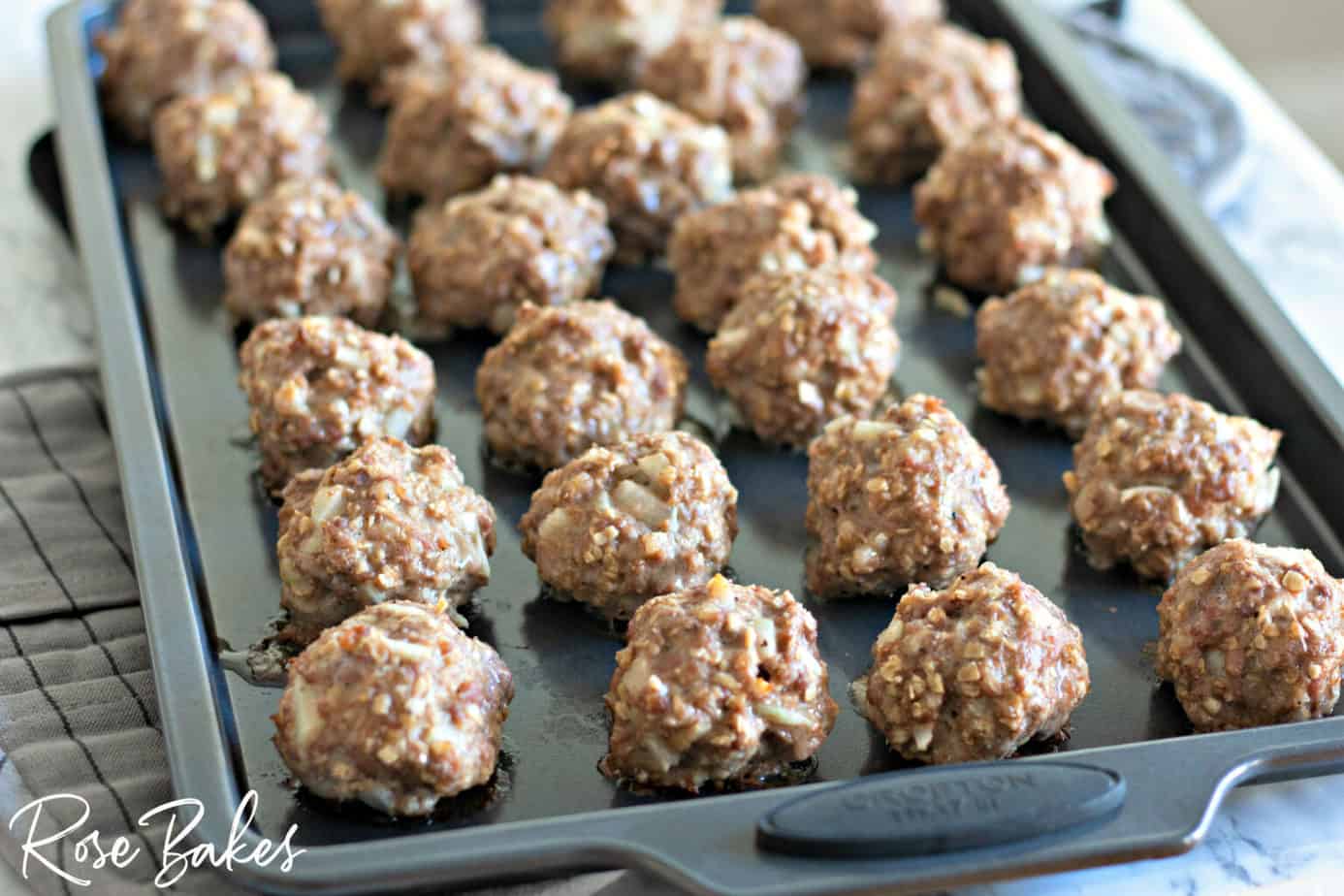 Cooked meatballs on a baking sheet