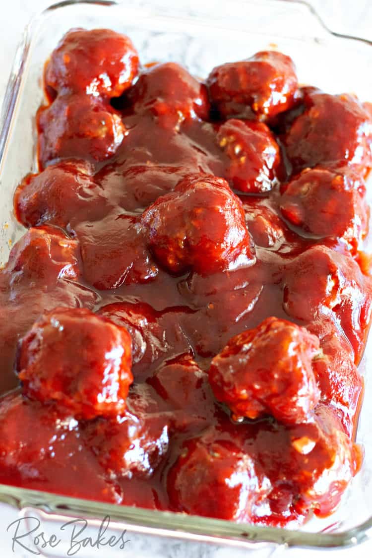 Baking dish filled with the meatballs covered in the cranberry bbq sauce