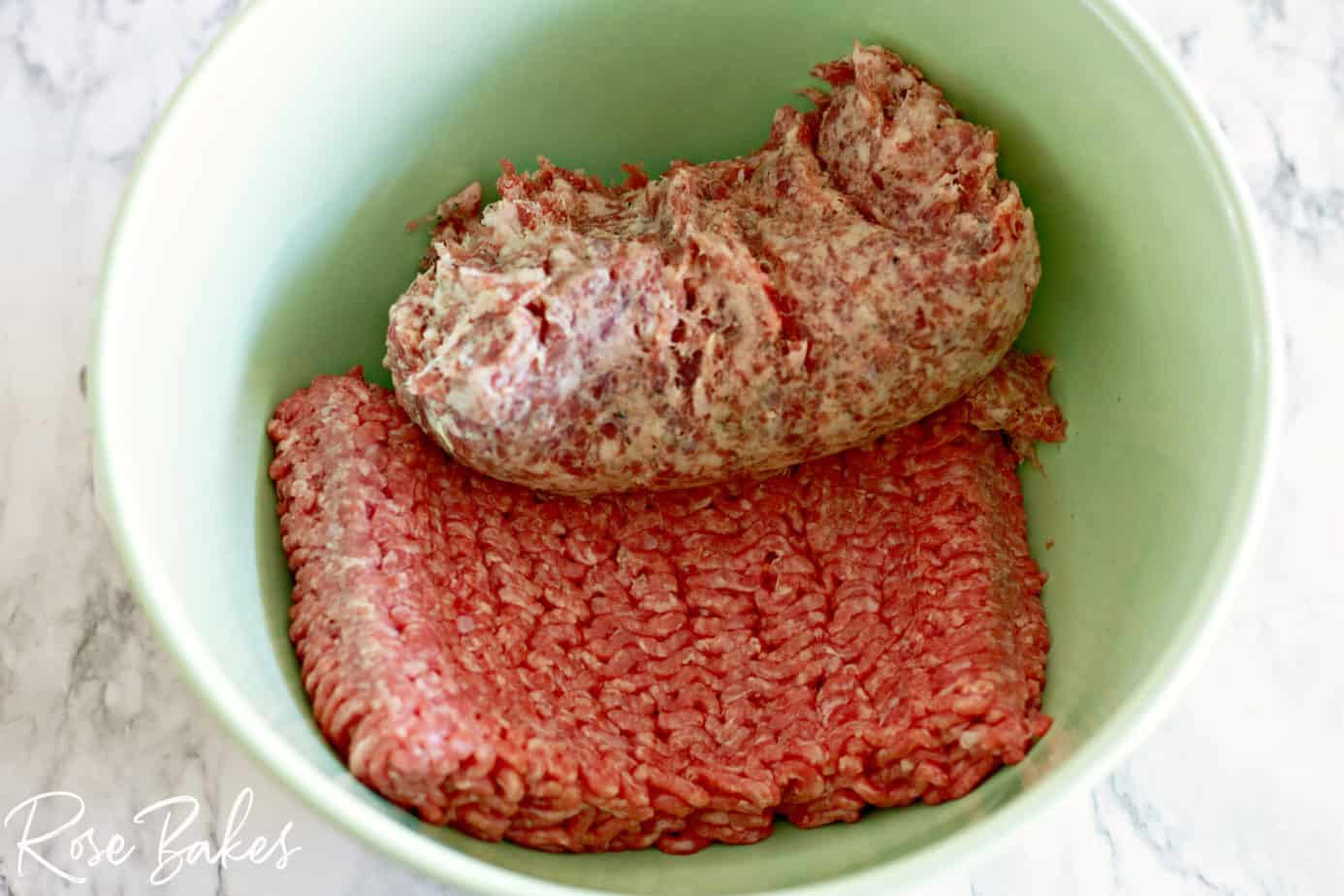 ground beef and sausage in a mixing bowl