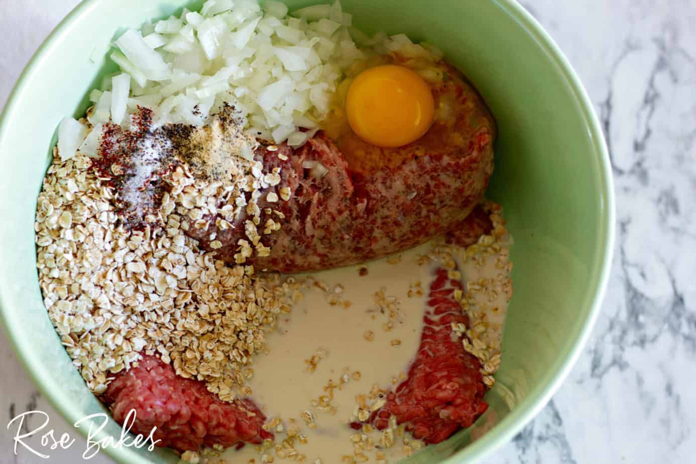all the ingredients for the meatballs in a mixing bowl