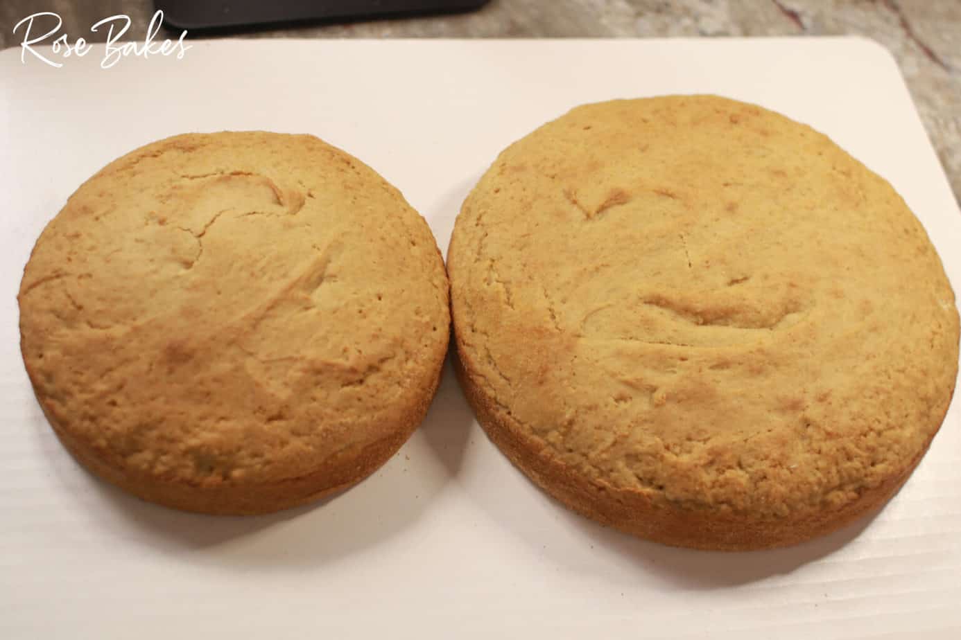 baked cakes on parchment paper to cool