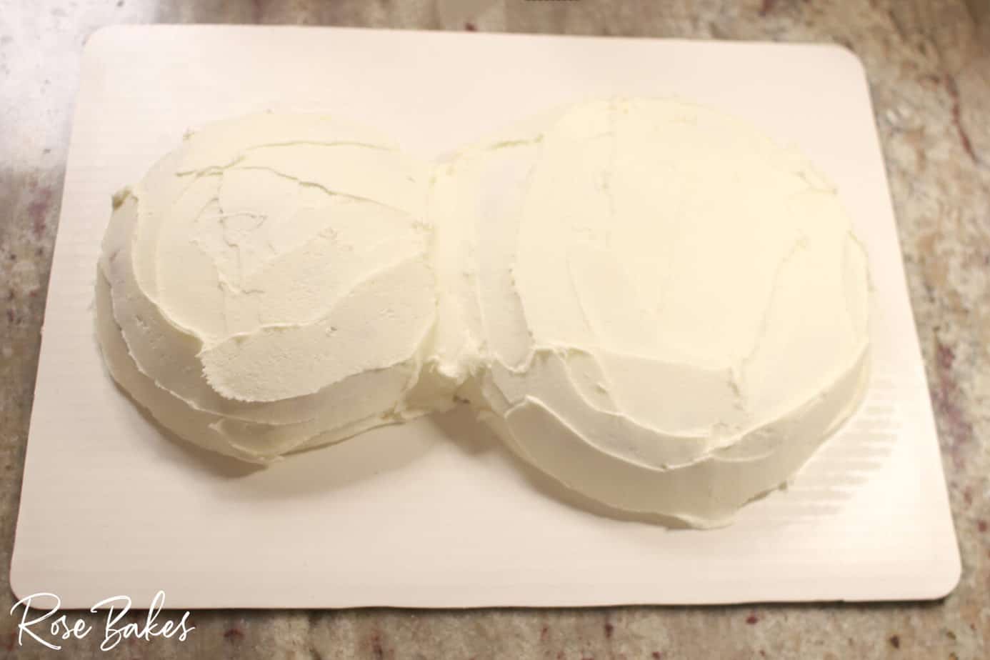 both cakes completely icing with white icing