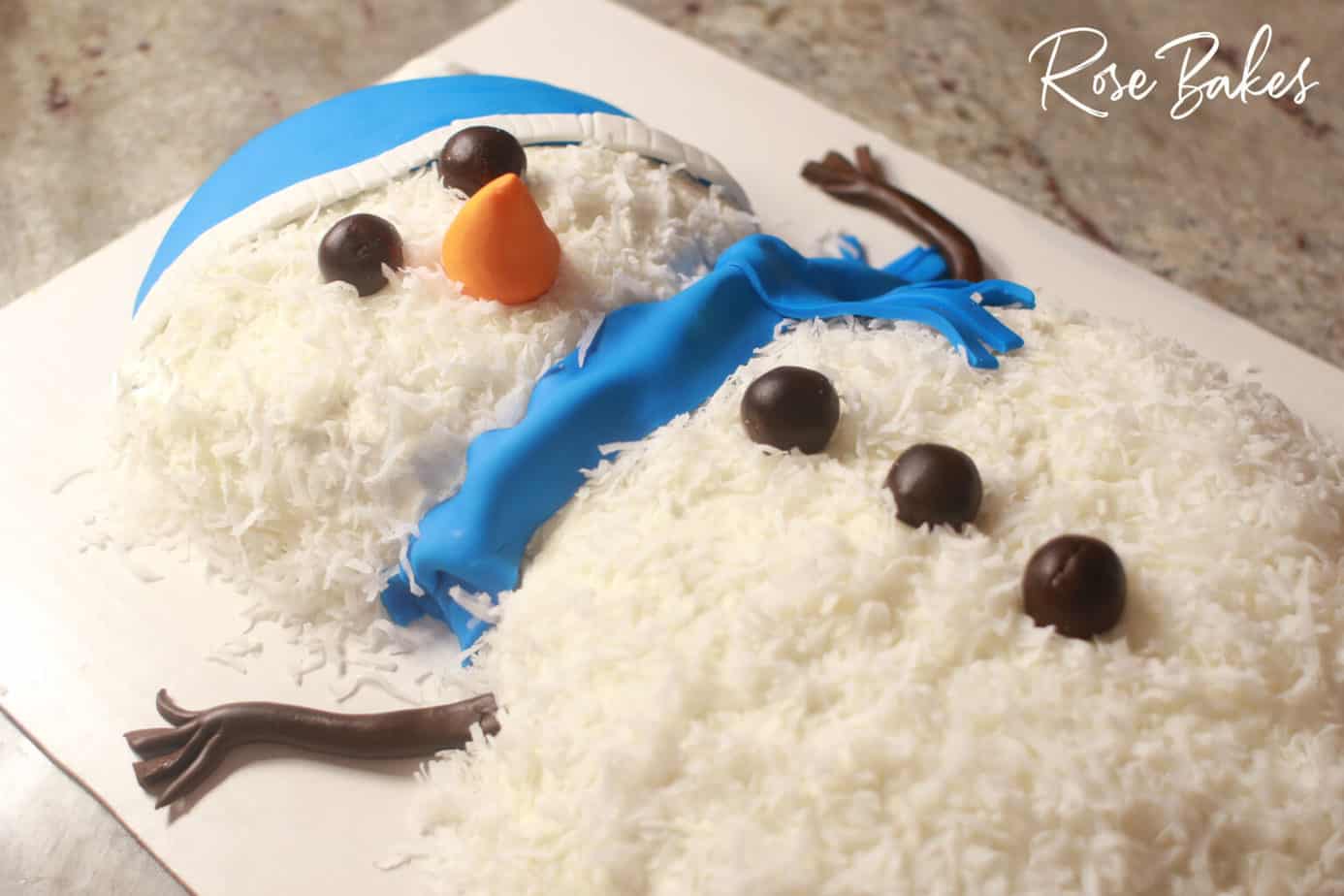 completed coconut honey snowman cake