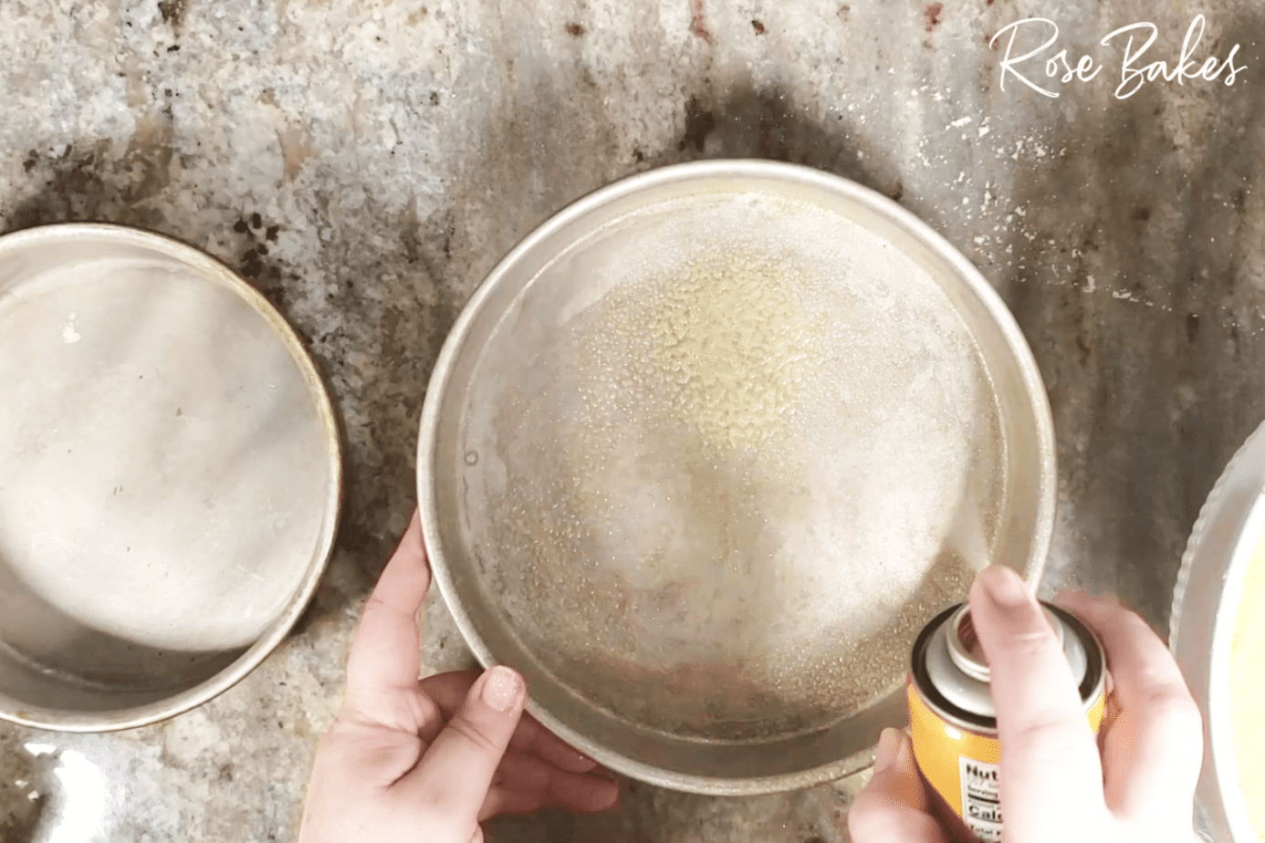 round cake pan being sprayed