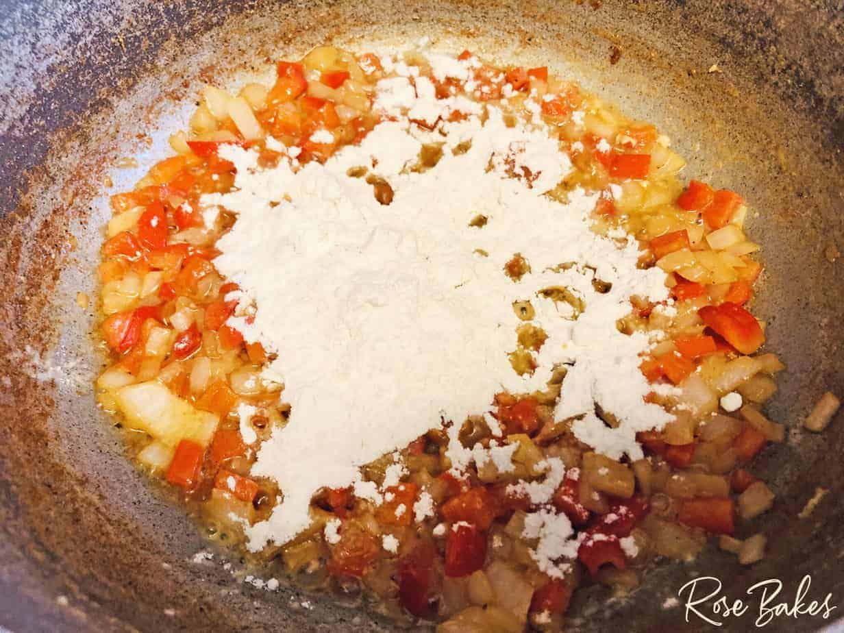 peppers and onions in skillet with butter
