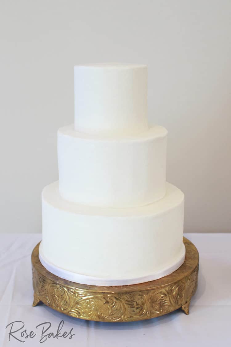All White Buttercream Wedding Cake on Gold Stand