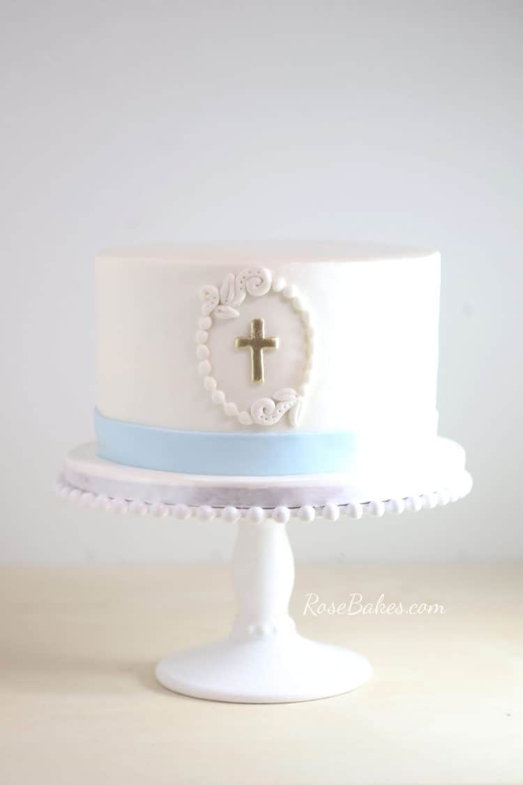 simple white 1 tier christenig cake on white stand