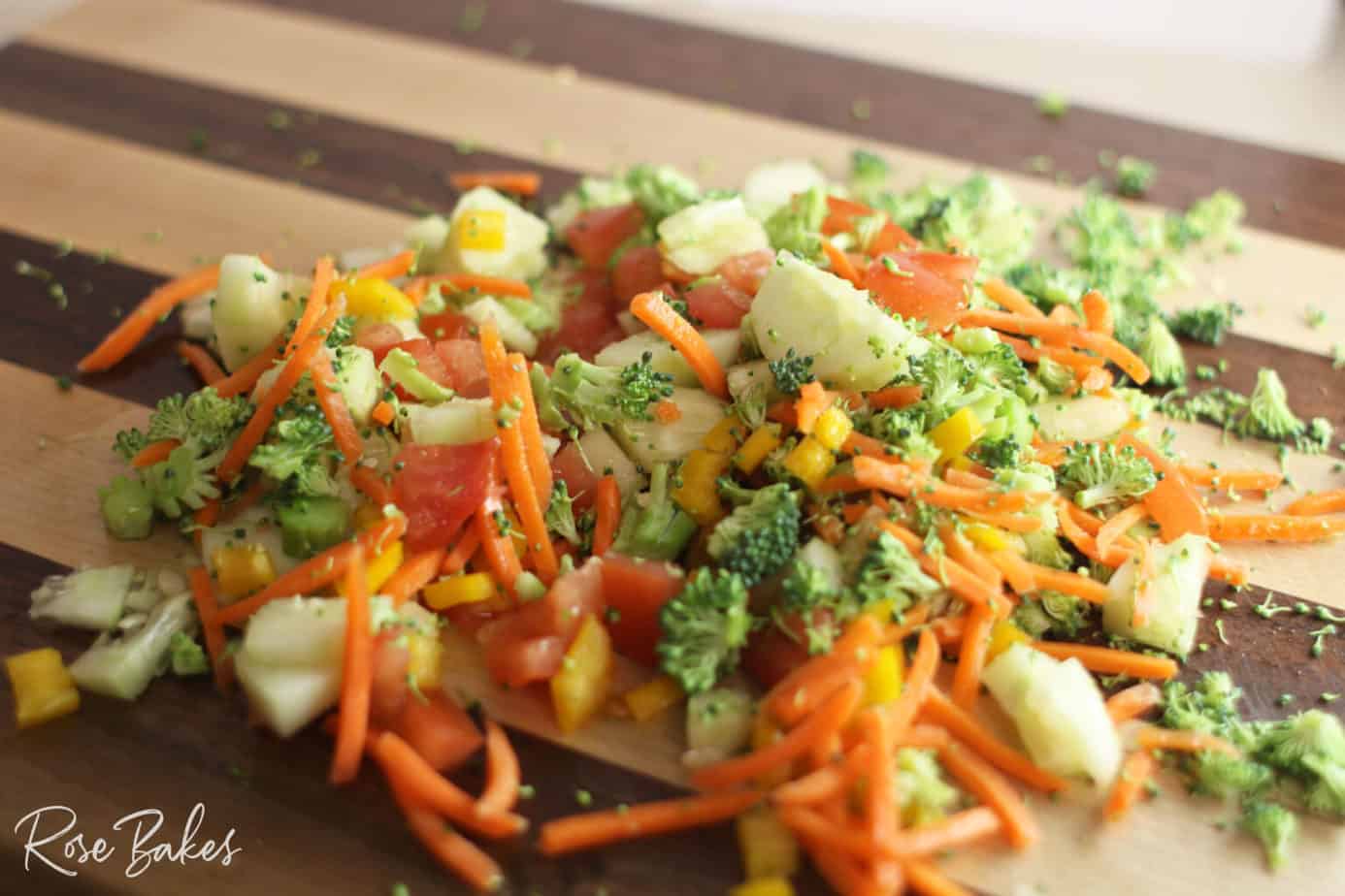 chopped veggies on a cutting board mixed up