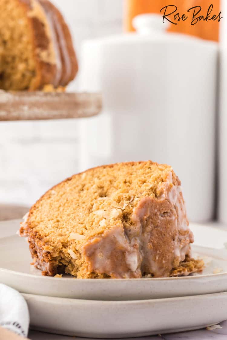 slice of easy coconut bundt cake on a stack of stoneware plates