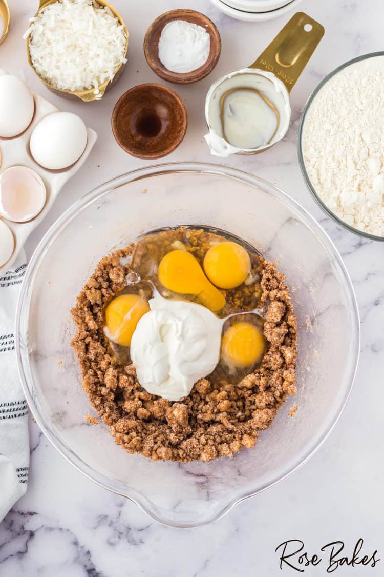 Eggs, vanilla, sour cream, and milk added to the sugar mixture