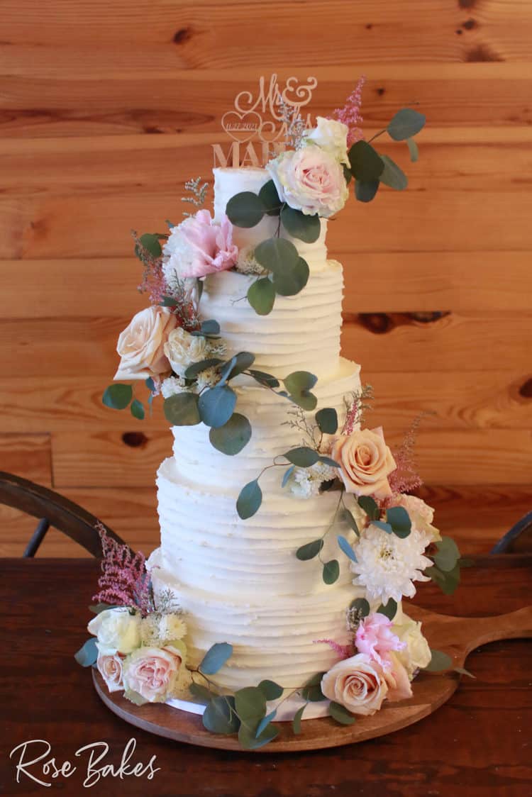 Lined-Buttercream-Wedding-Cake-with-Fresh-Flowers-Cascading