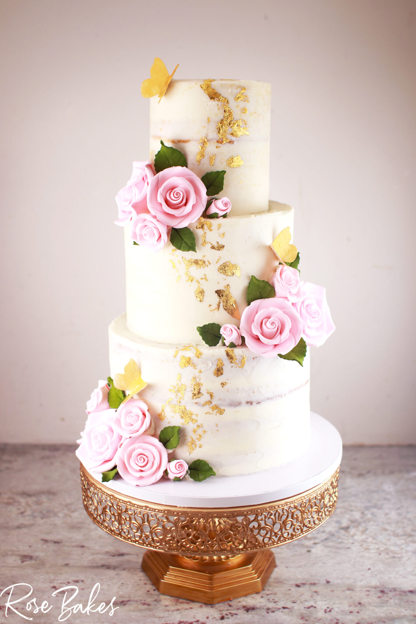 Naked-Wedding-Cake-with-Pink-Sugar-Roses-and-Gold-Leaf-and-Gold-Butterflies