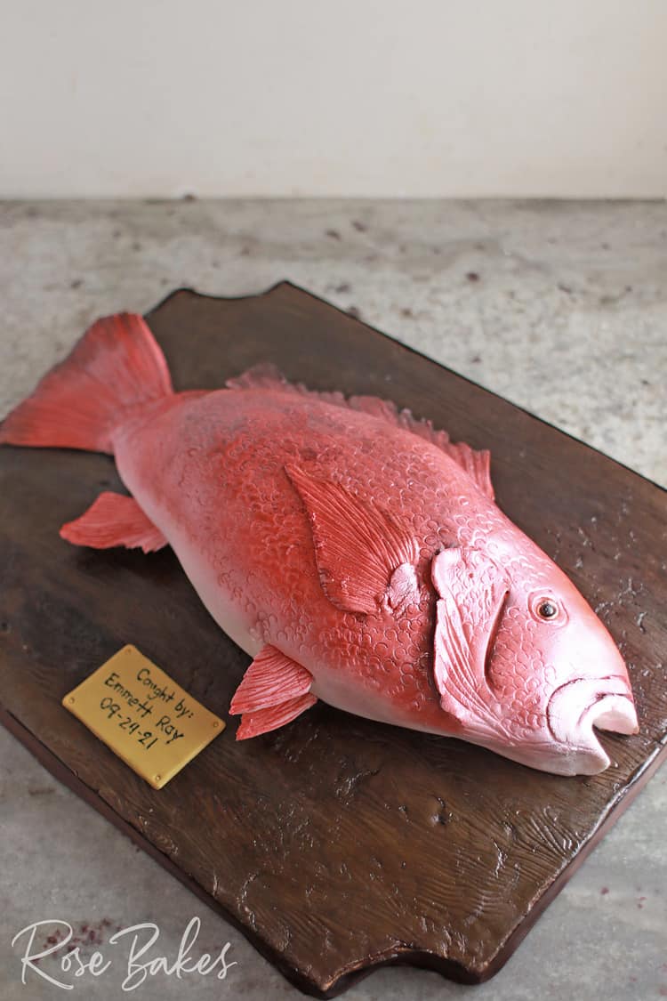 red fish look a like cake on wooden stand