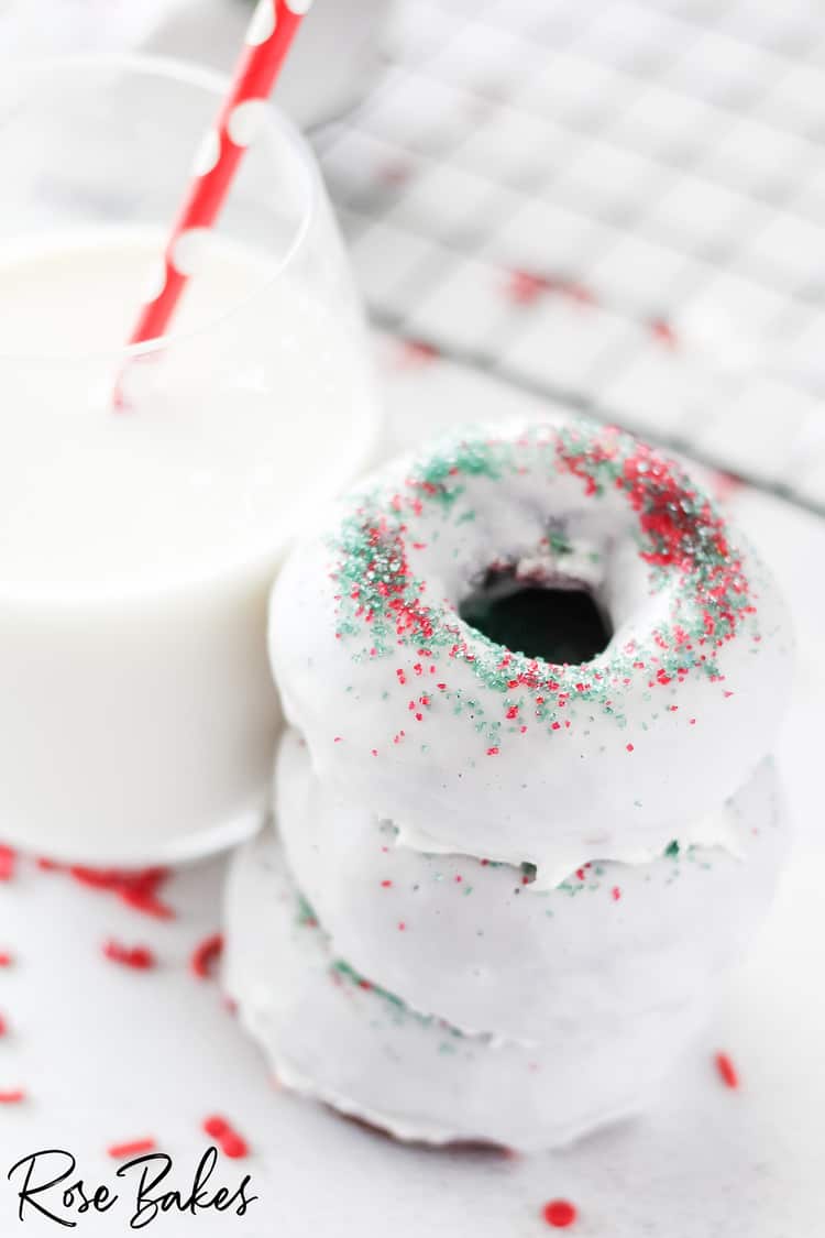 Stack of donuts next to glass of milk