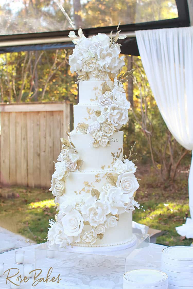 cascading flowers with gold tall wedding cake with gum paste sugar flowers
