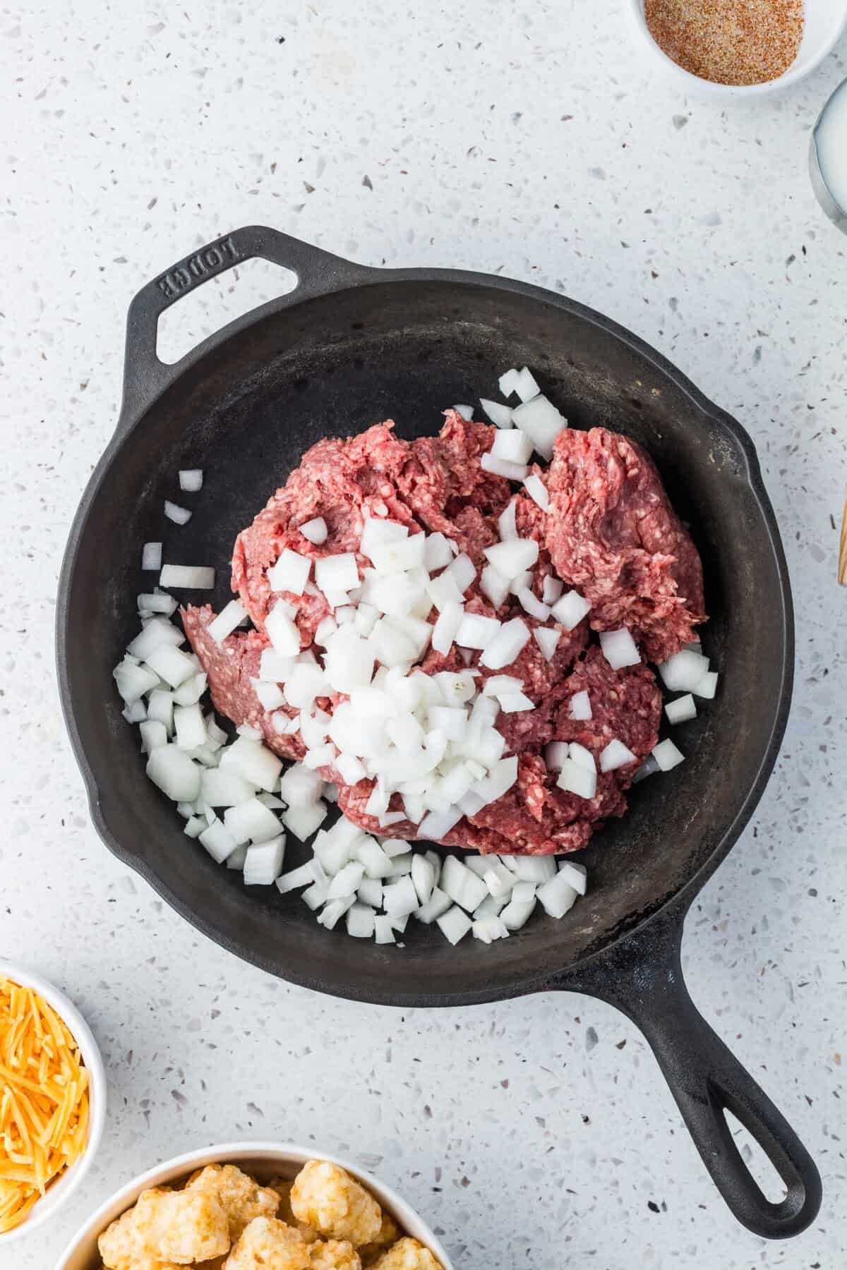 ground beef and diced onions in a skillet