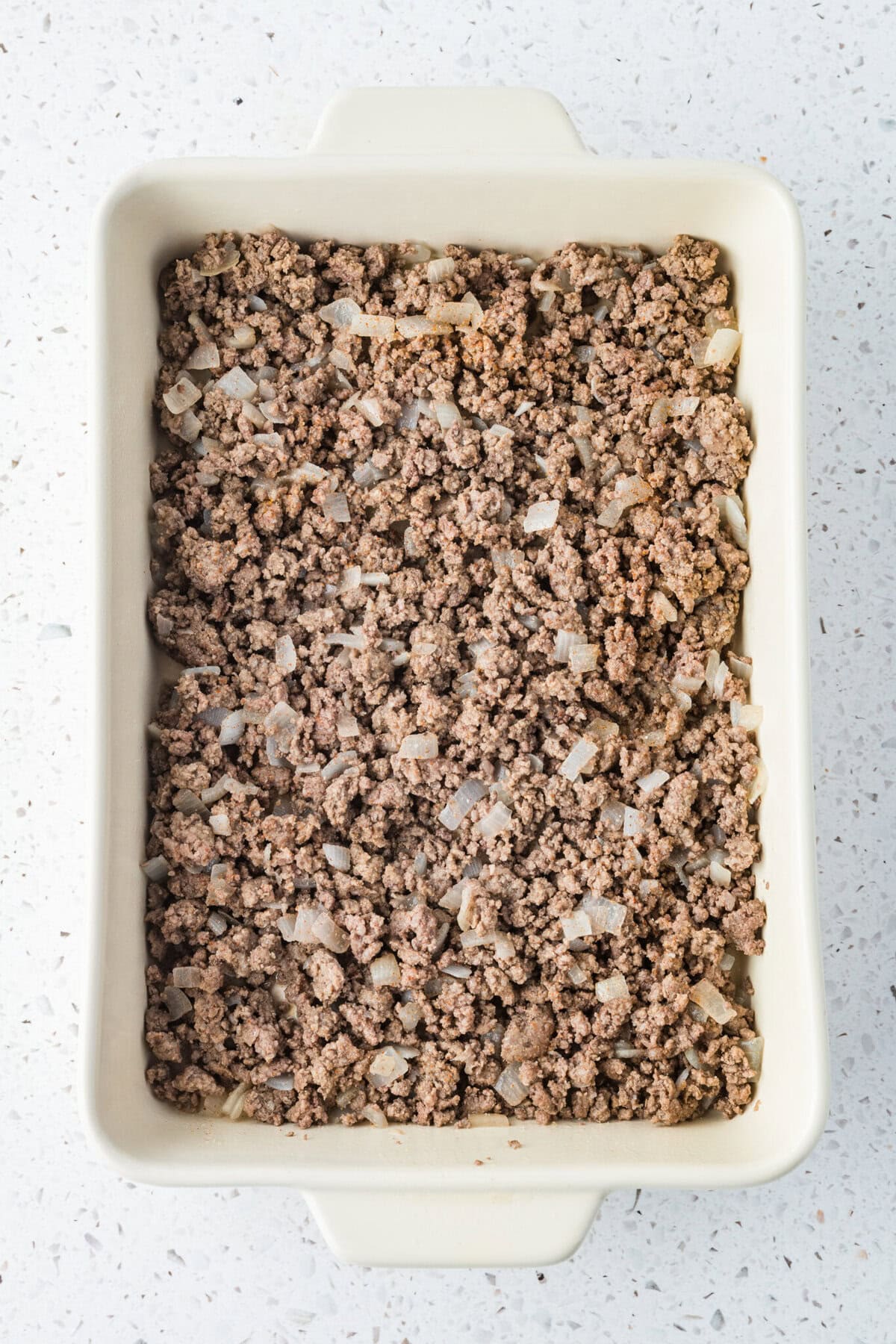 tater tot casserole process 03 cooked ground beef and onions in a 9x13 baking dish