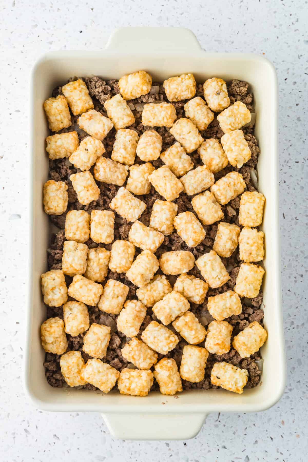 frozen tater tots on ground beef in 9x13 dish