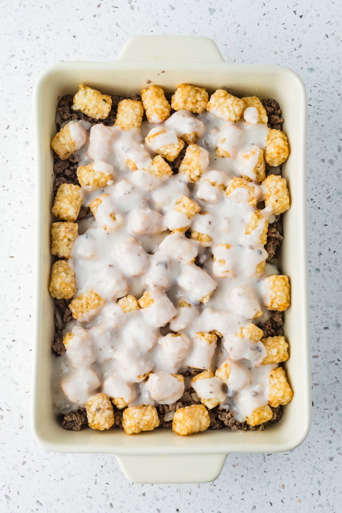 soup mixture poured over tater tots