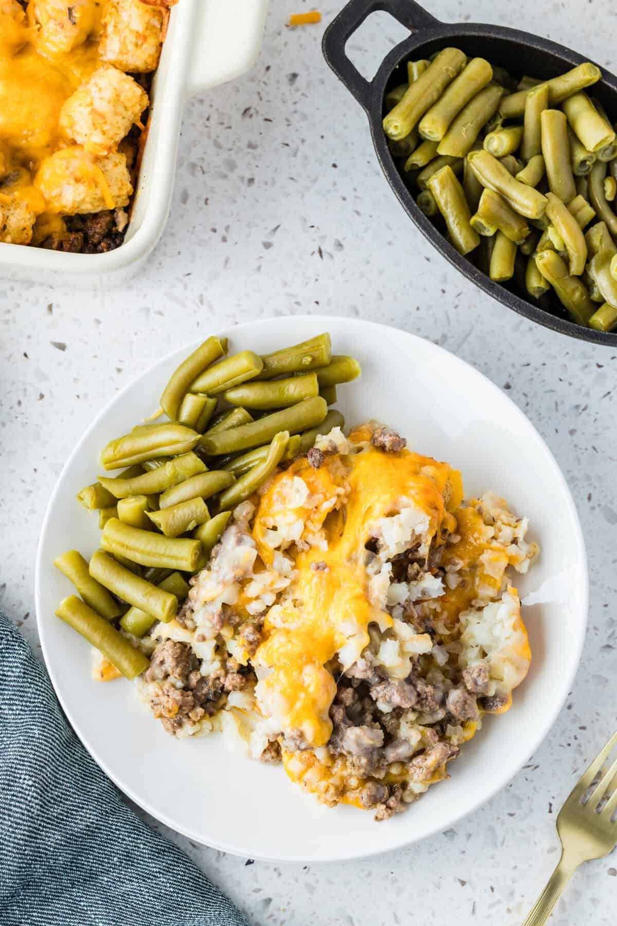 tater tot casserole with green beans on a plate