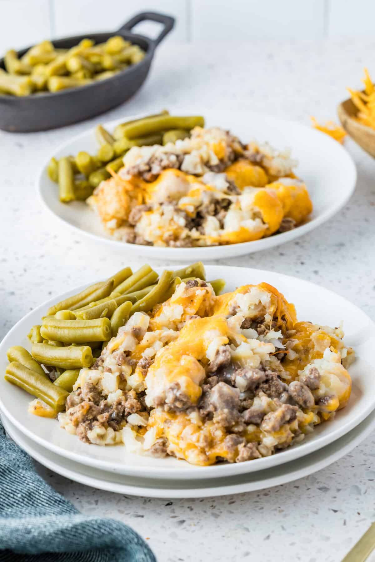 tater tot casserole with green beans on plates