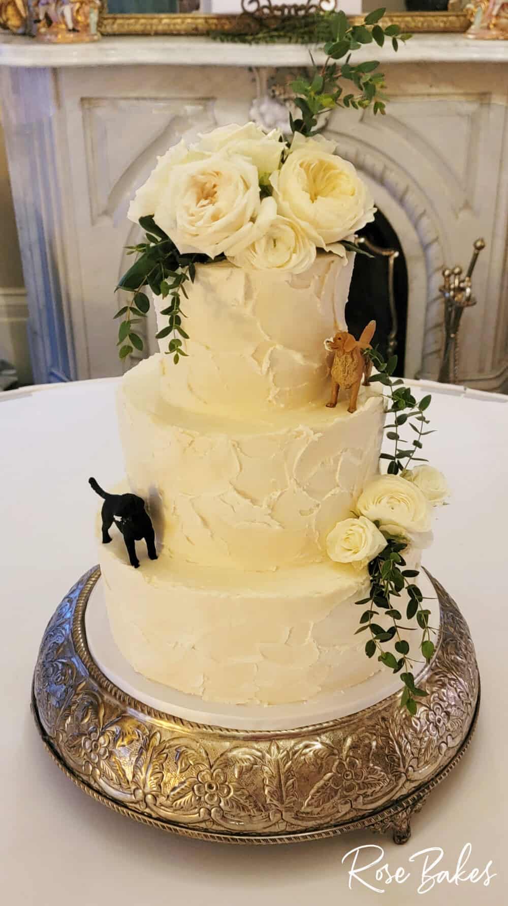 White Textured Buttercream Wedding Cake with White Roses and Greenery with Dogs