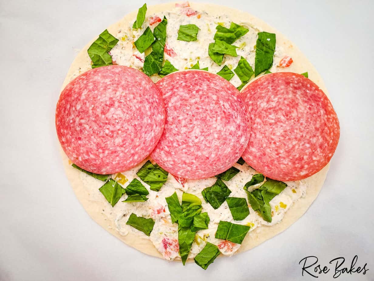 hard salami slices on tortilla