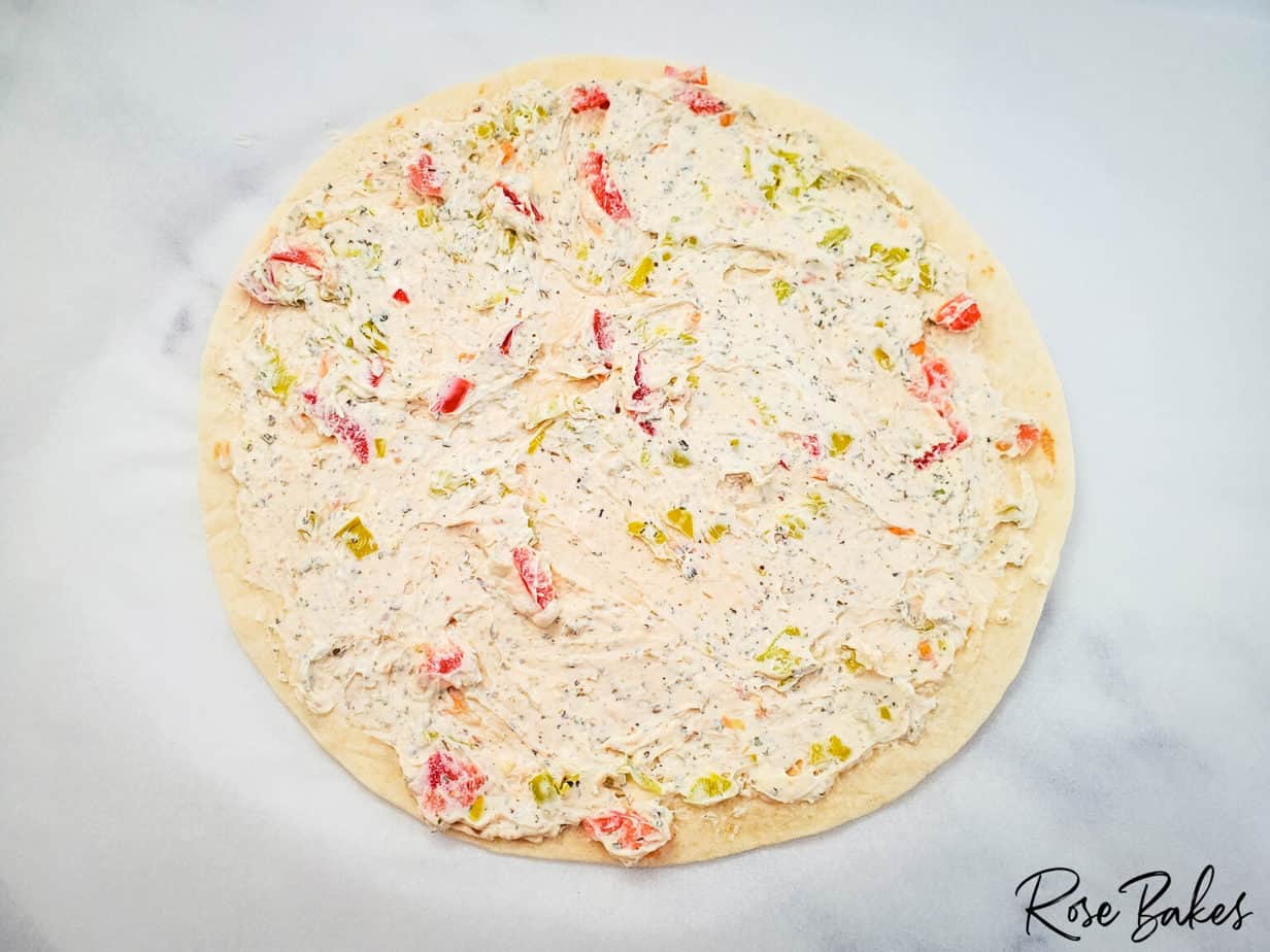 spreading cream cheese mixture to edges of tortilla