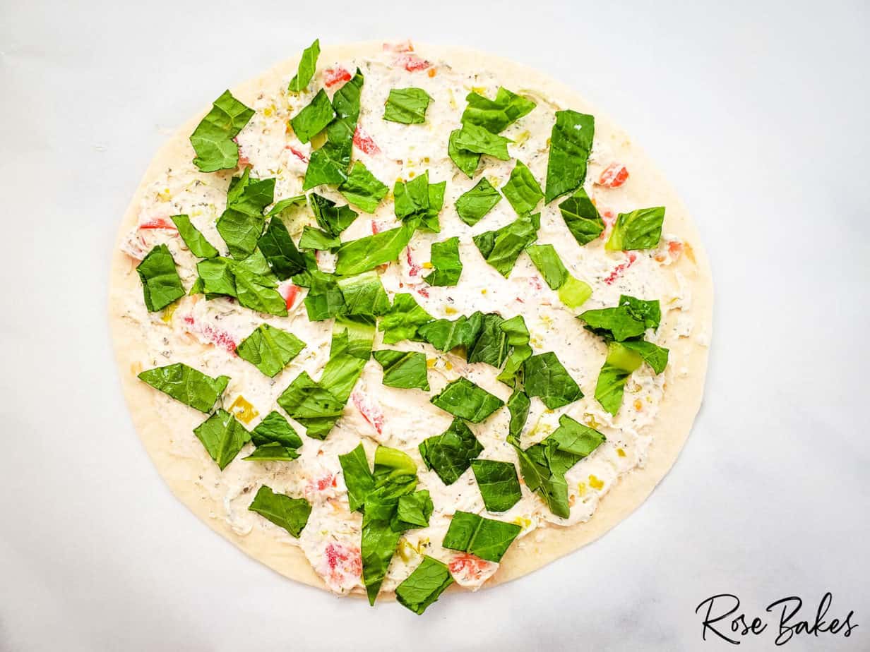 lettuce on cream cheese mixture on tortilla