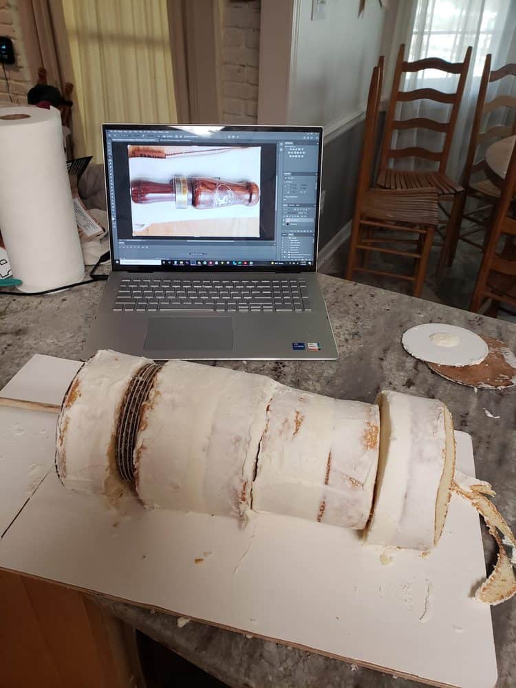 Duck Call grooms cake work table with laptop and cake to be trimmed shown
