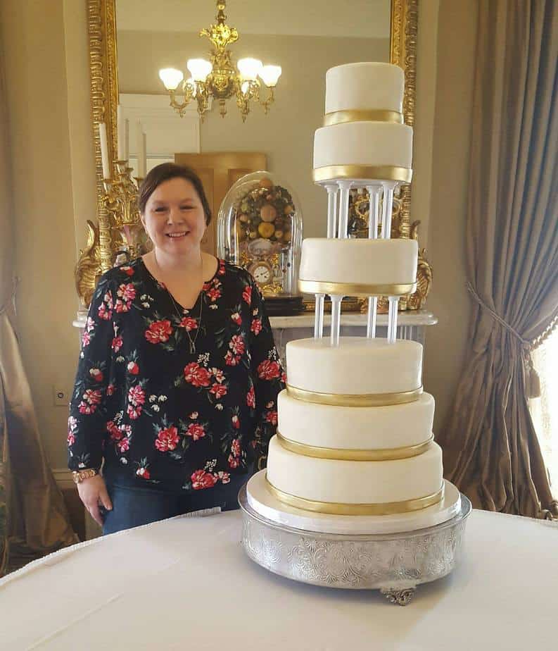 Rose with 6 tiered white wedding cake with gold accents