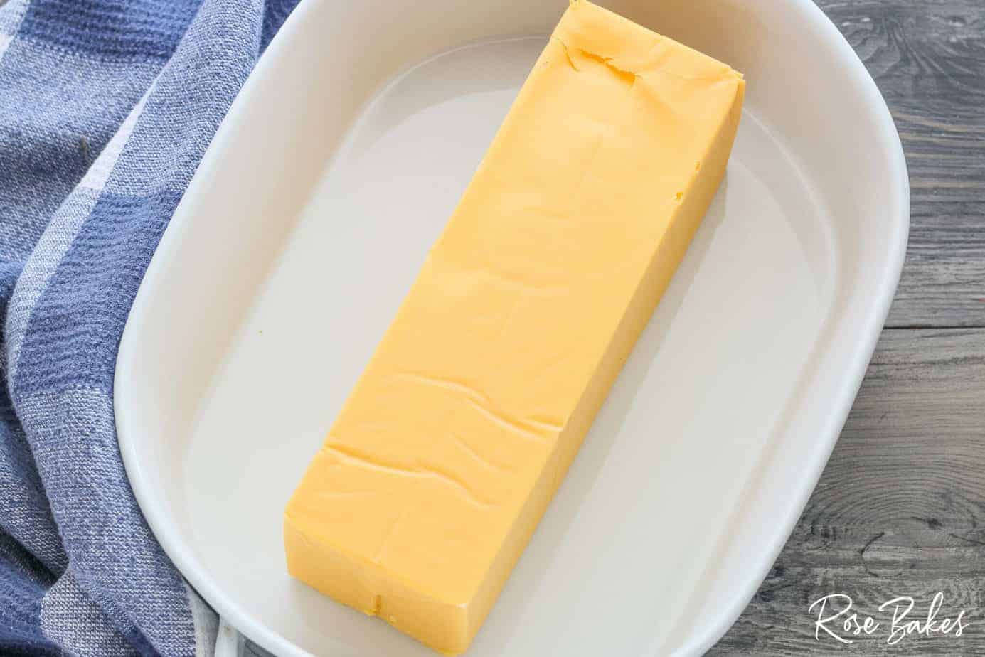 white serving dish with velveeta cheese inside