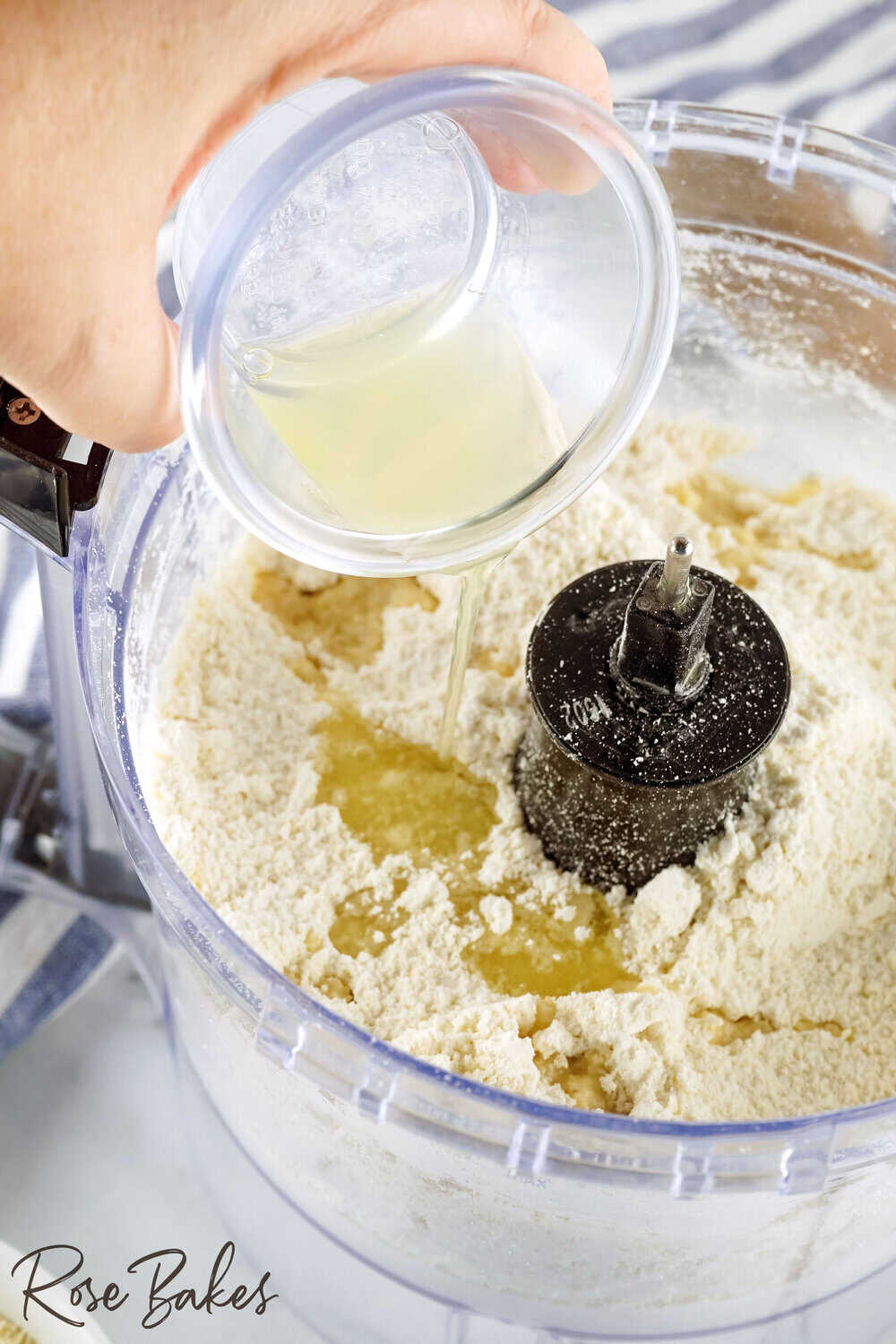 egg white being added to bowl for the homemade almond paste