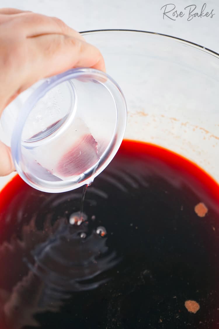 strained beet juice in large bowl with vinegar added 
