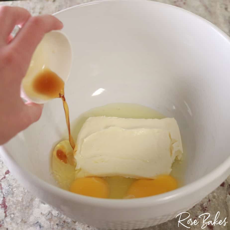 ingredients for icing being added to mixing bowl