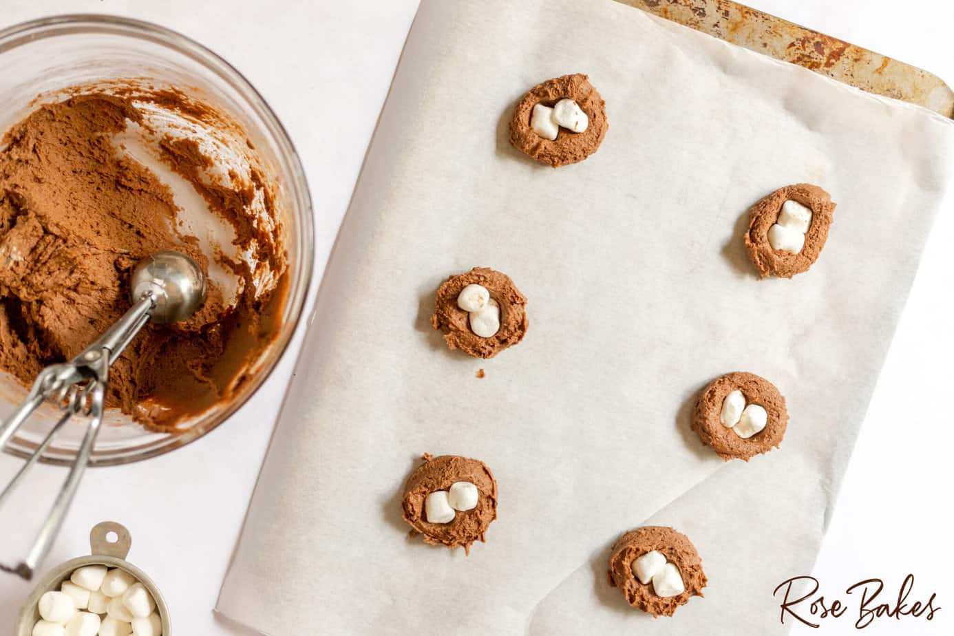marshmallows being placed in center of unbaked cookies
