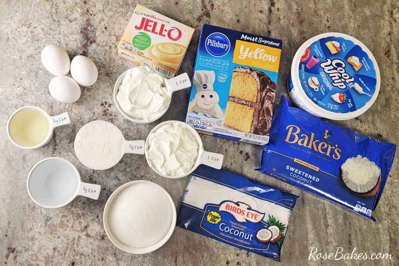  coconut poke cake ingredients laid out on gray granite counter top