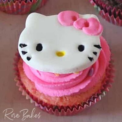 hello kitty cupcake topper on pink frosting on a cupcake