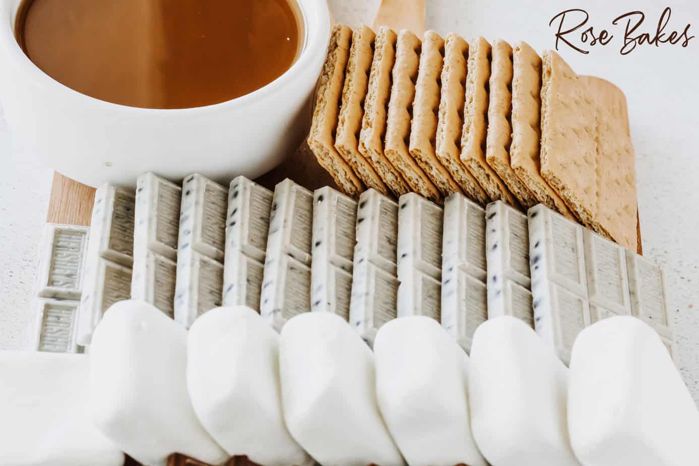 Add cookies & cream bars, graham crackers and a bowl of caramel sauce to one side of the marshmallows